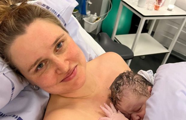 Mor med nyfødt baby på brystet